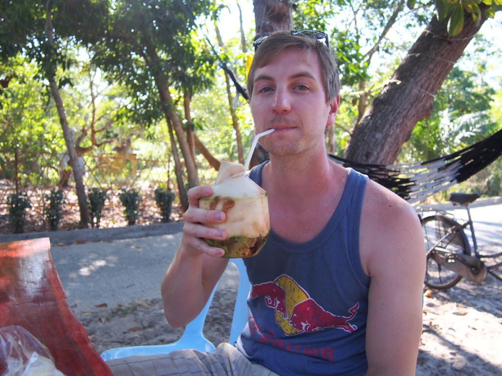 Hanging out, drinking coconut water out of a fresh coconut. No biggie